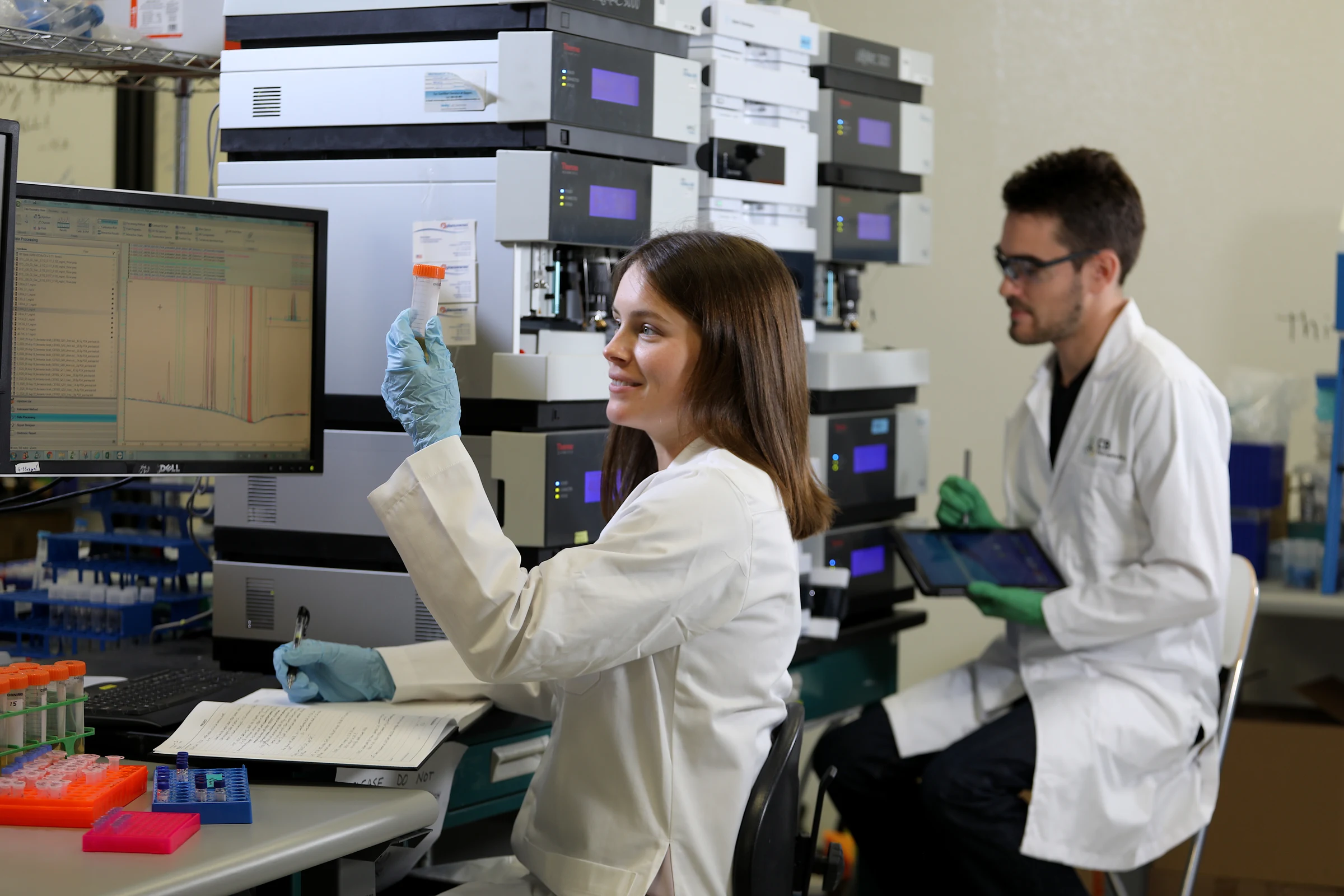 CB Therapeutics scientists operating HPLC analytical equipment at the Carlsbad, CA facility